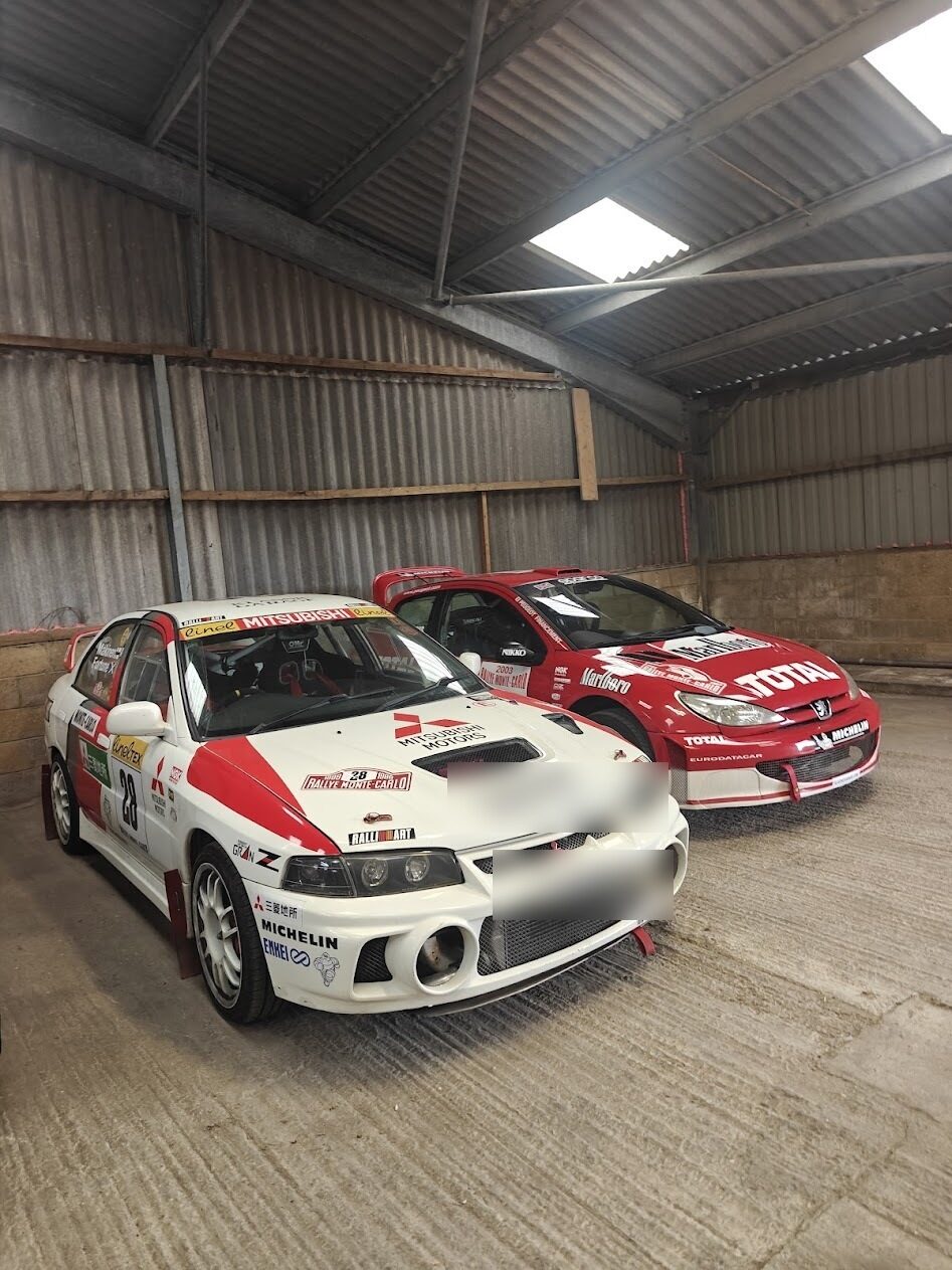 Mitsubishi Evo IV rally car in the garage, Monte Carlo livery with rally plates